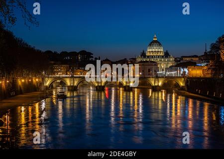 View over the Tiber at evening light on Ponte Sant`Angelo and St. Peter's Basilica, Rome, Italy Stock Photo